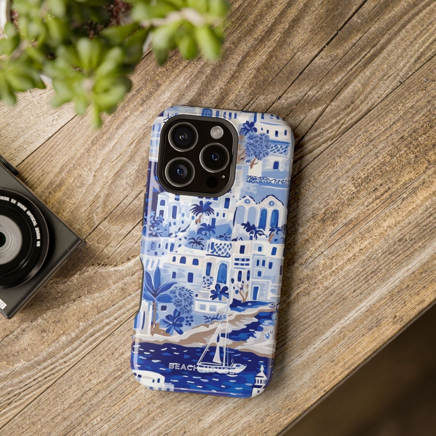 Santorini MagSafe Tough Case for iPhone with blue and white coastal pattern on a wooden surface