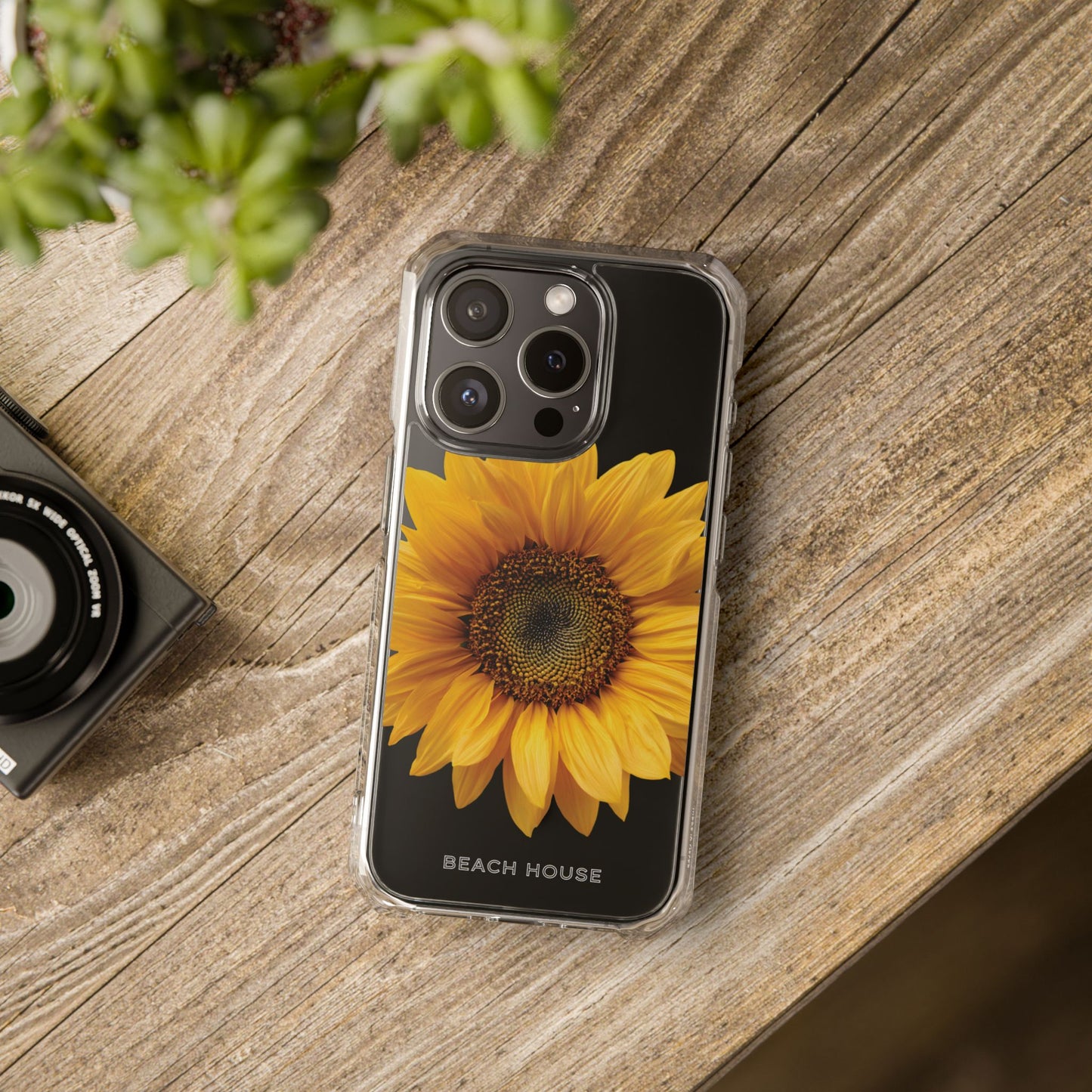 Phone case with sunflower design on a wooden surface