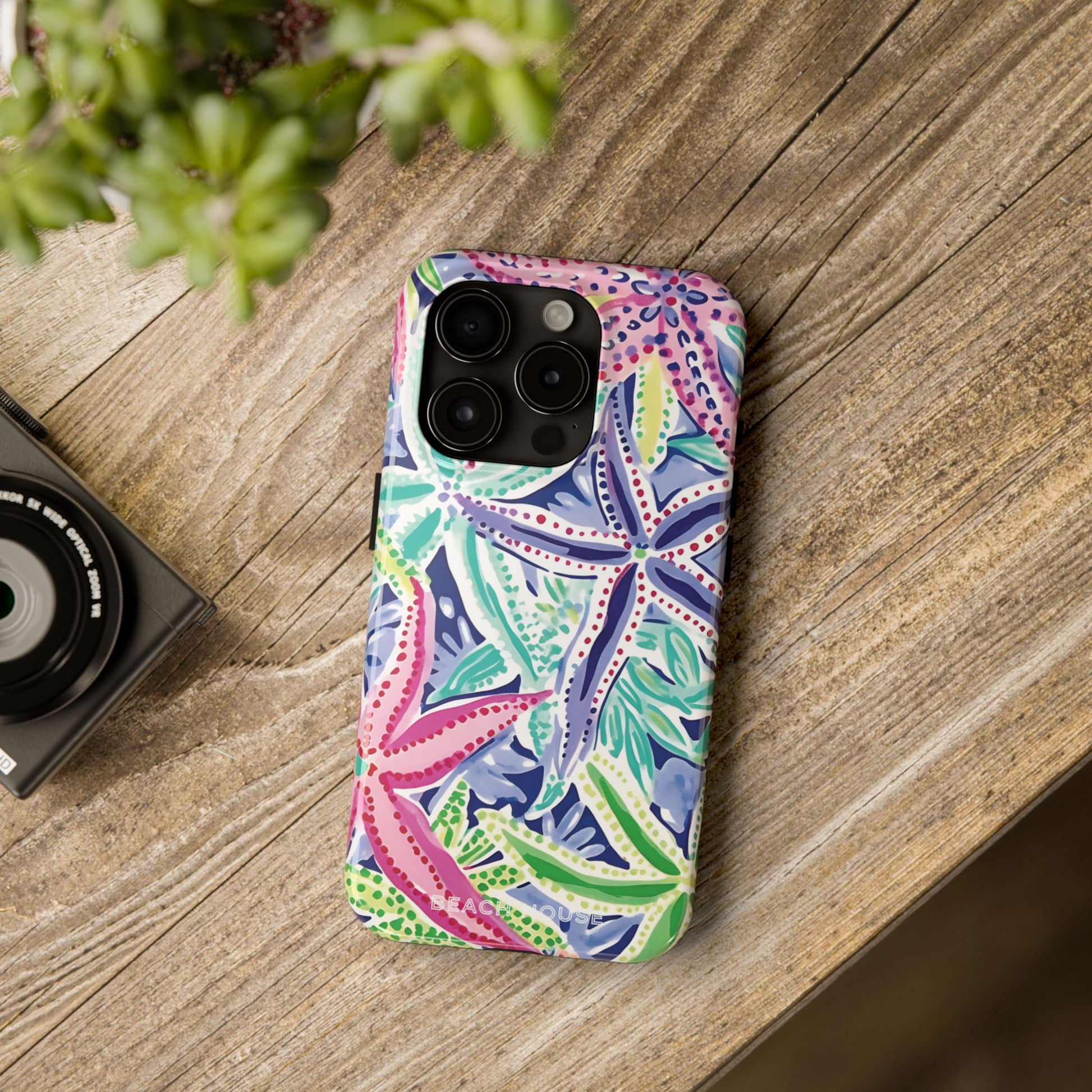 Colorful Siesta Key Tough Case for iPhone with a starfish pattern on a wooden surface