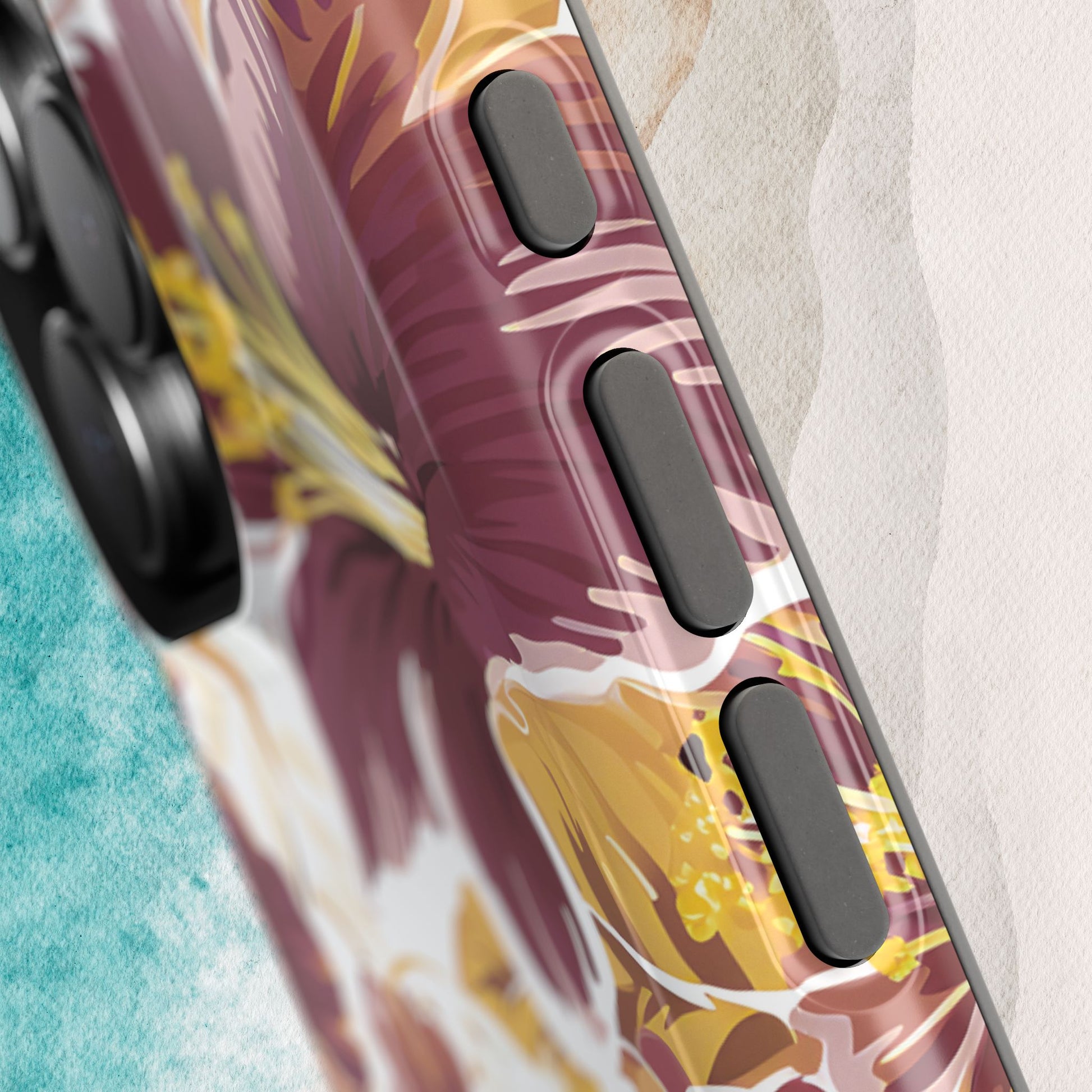 Detailed view of buttons on Tallahassee MagSafe Tough Case for iPhone with abstract design on a textured surface