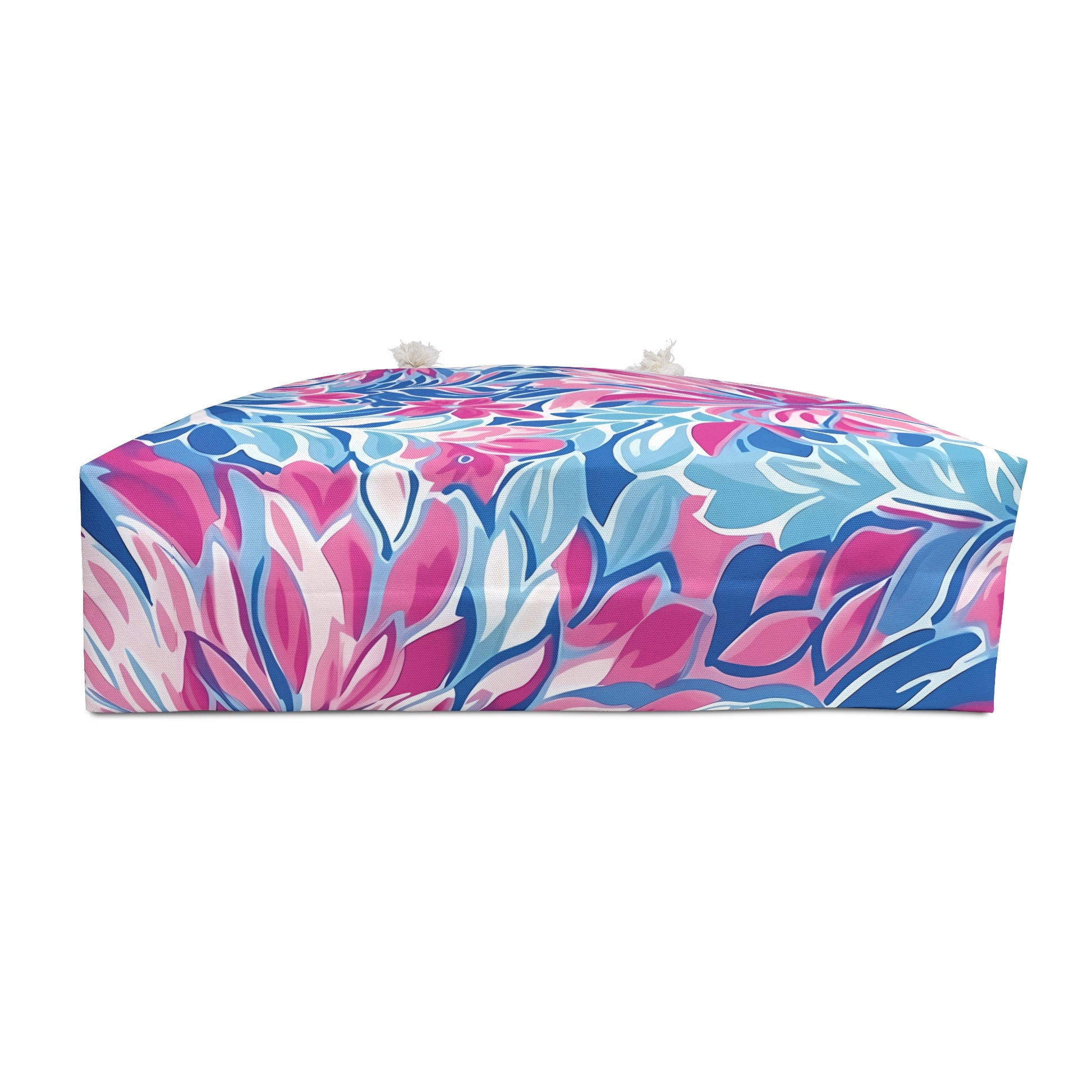 Bottom of the Destin weekender tote bag with pink and blue design on a white background