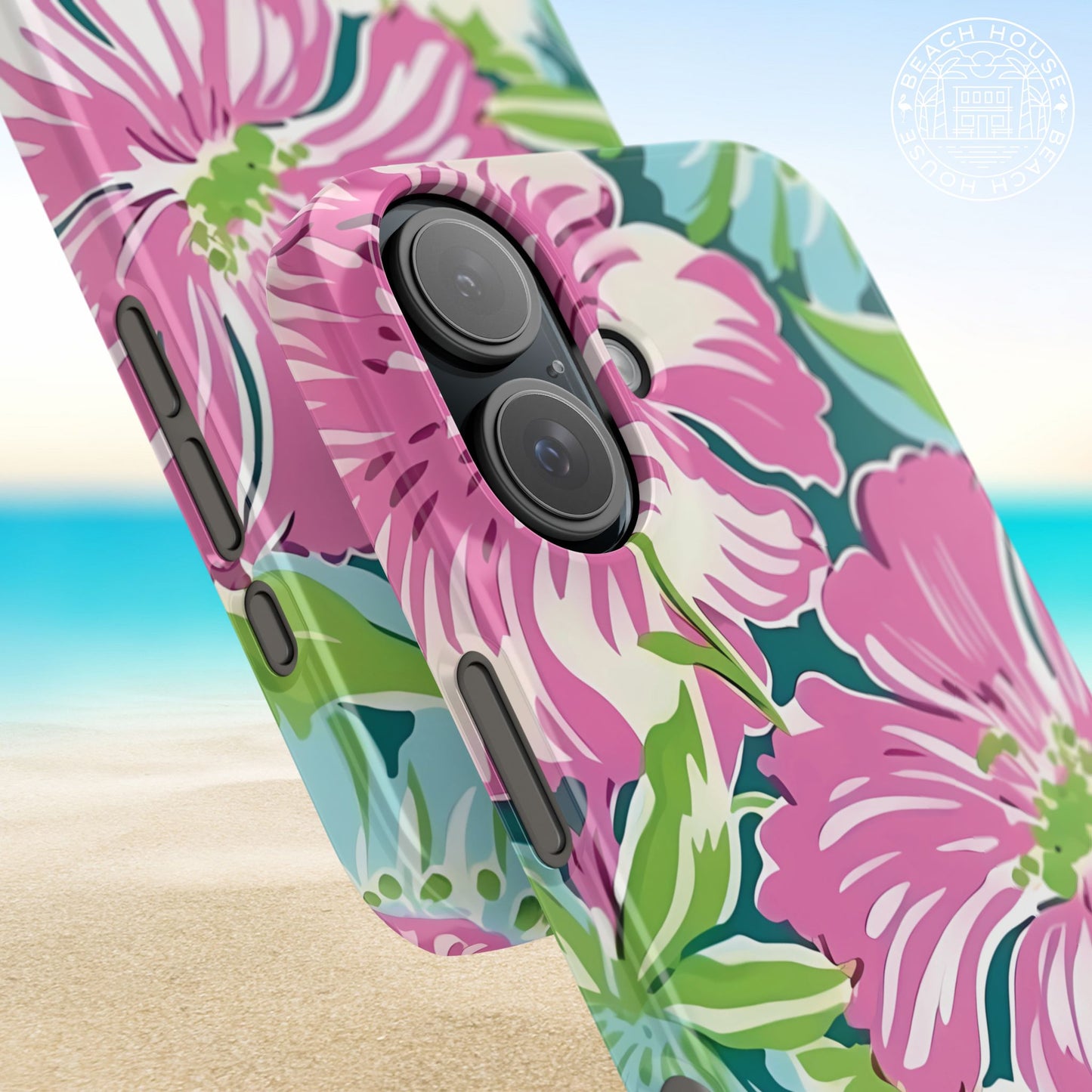 Close up views of the Seaside Slim Case for iPhone with pink floral design on a beach background