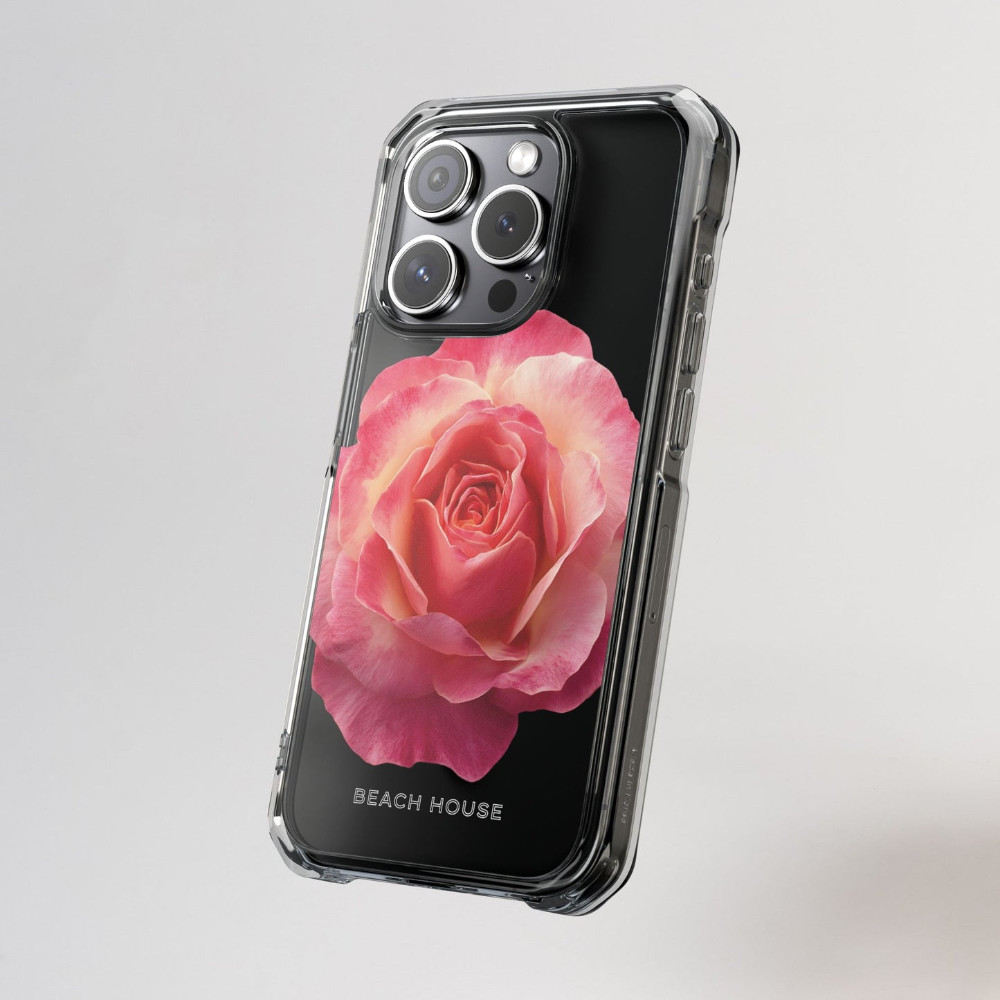 Phone case with a pink rose design on a gray background