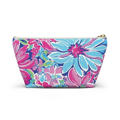 Floral patterned pouch with a gold zipper on a white background