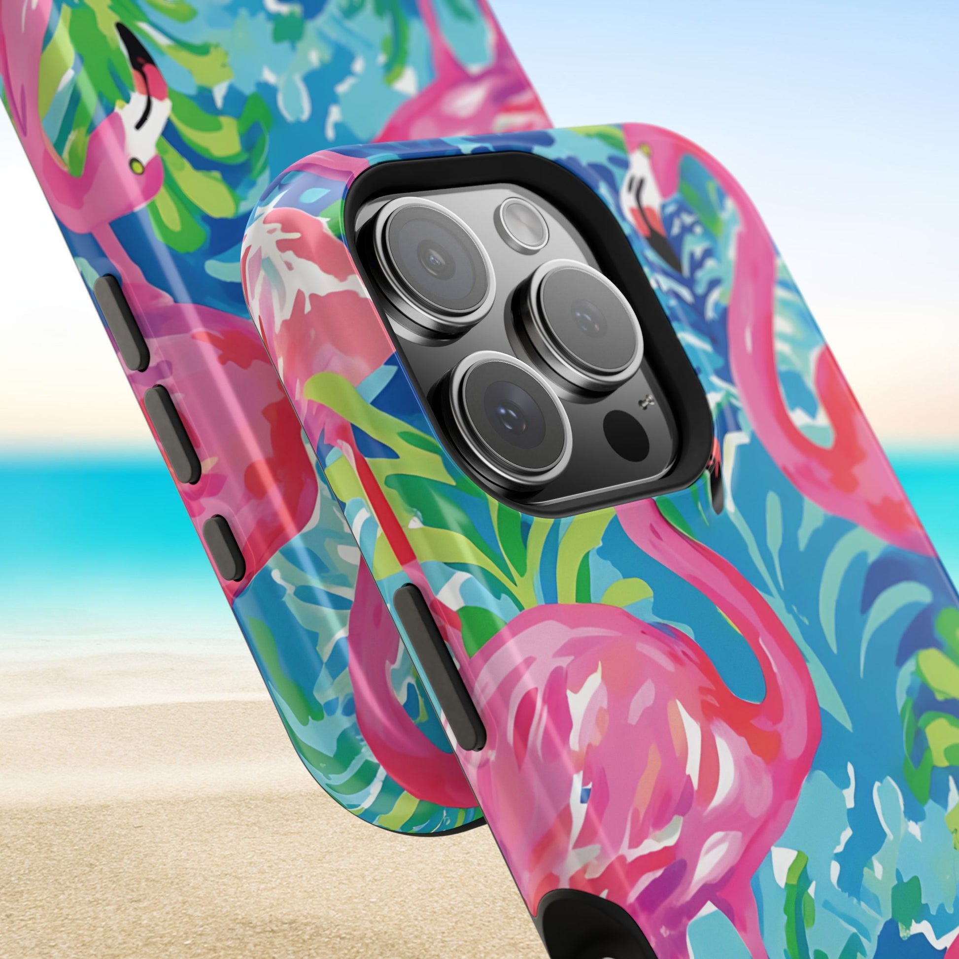 Close up views of the Key Largo MagSafe Tough Case for iPhone with flamingo design on a beach background