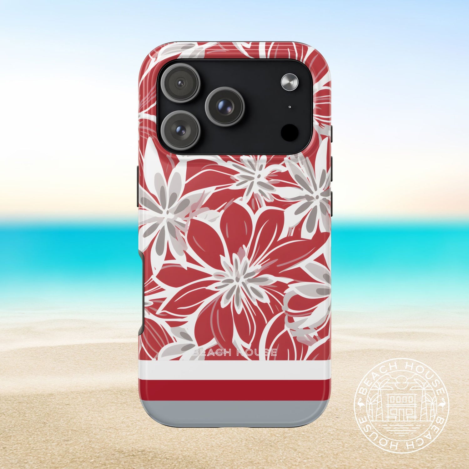 Columbus Tough case for iPhone with red and white floral design on a beach background