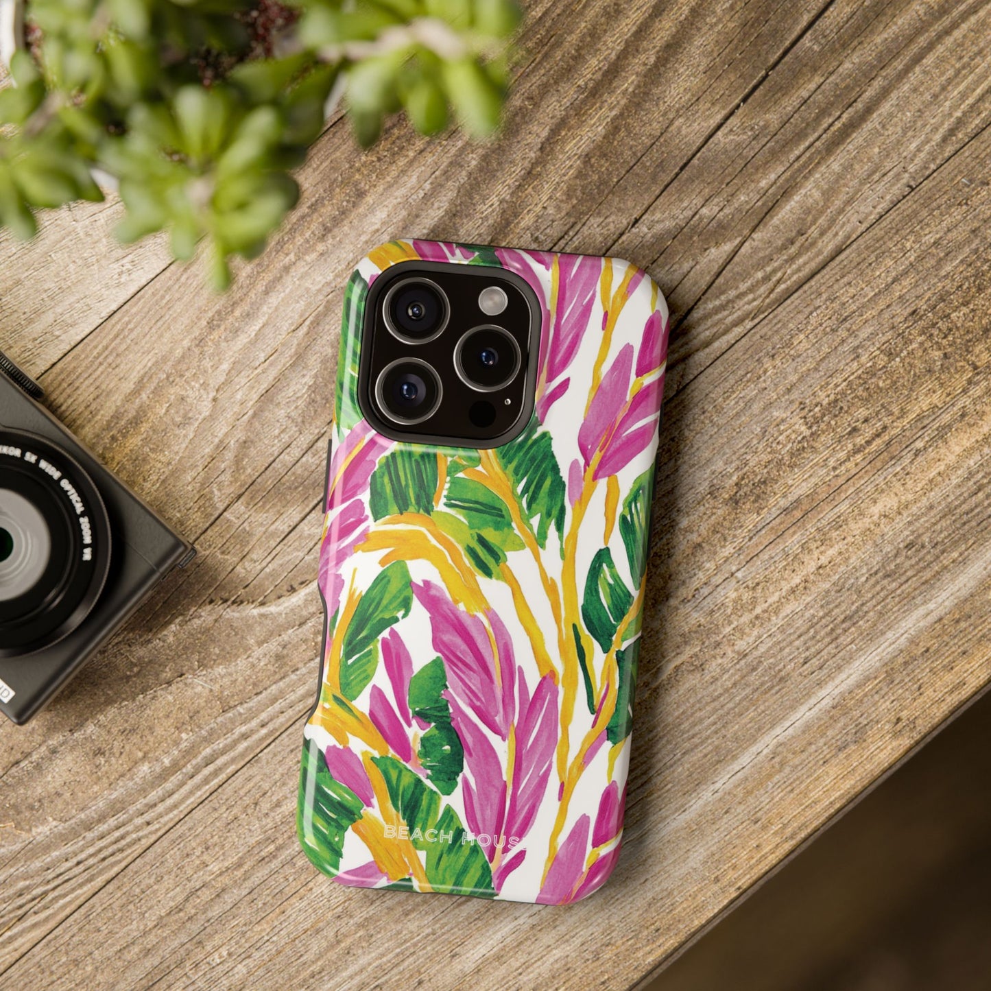 Naples MagSafe Tough Case for iPhone with leaf pattern on a wooden surface