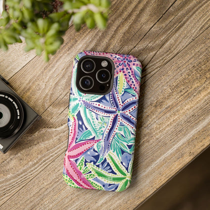 Siesta Key MagSafe Tough Case for iPhone on a wooden surface with a camera and plant in the background