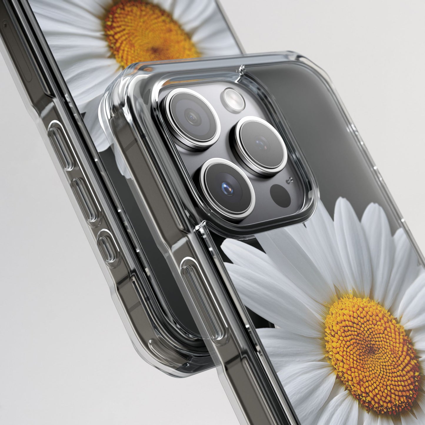 Smartphone with a clear case on a white background with daisies.