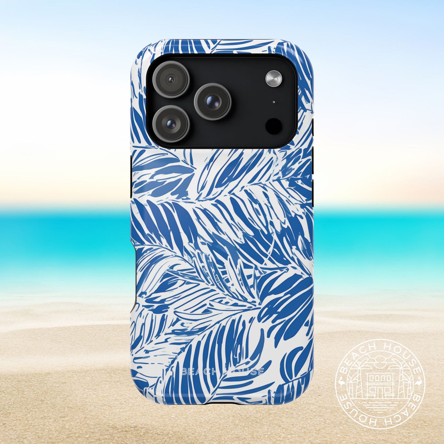 Hampton MagSafe Tough Case for iPhone 17 Pro with blue leaf pattern on a beach background