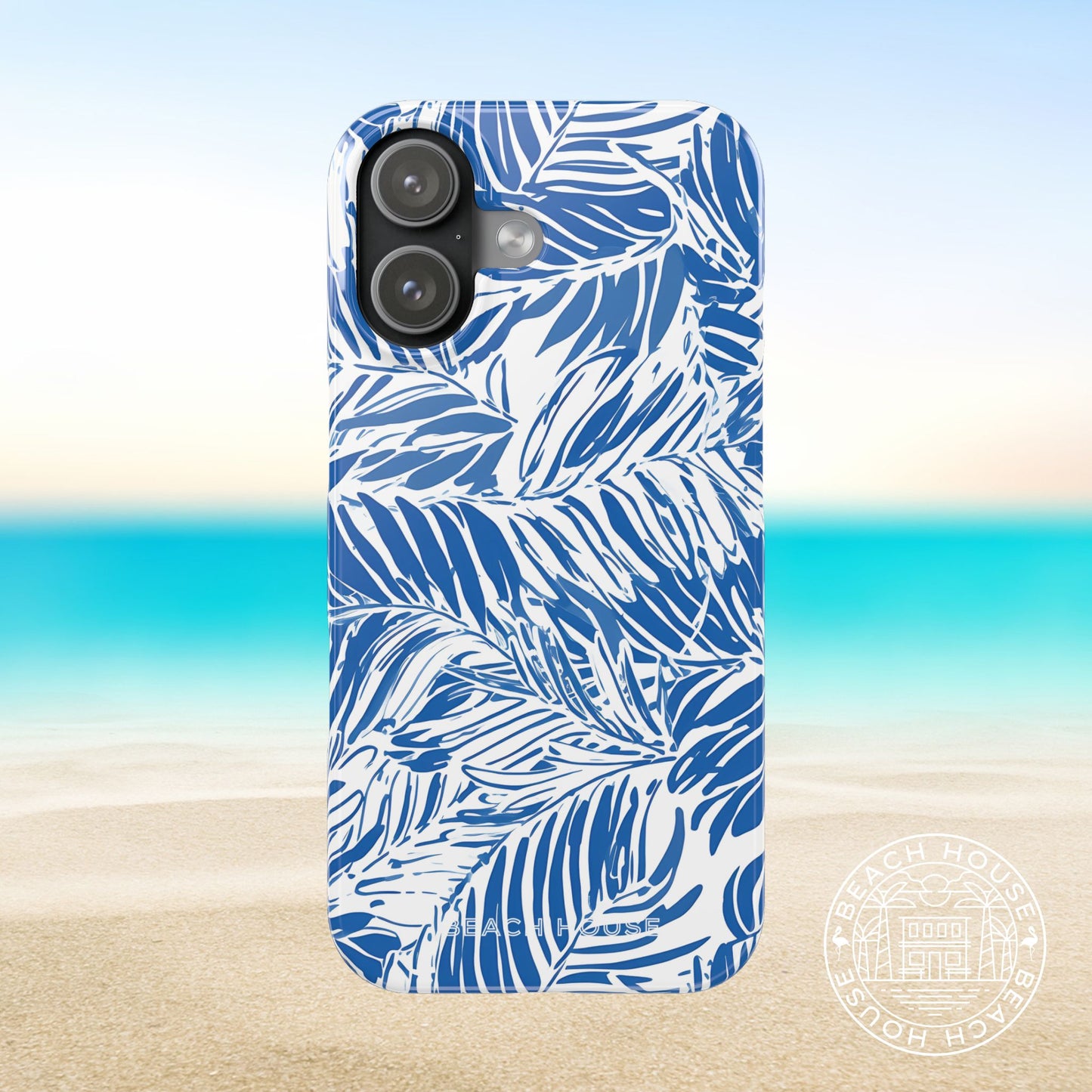 Hampton Slim Case for iPhone 17 with blue leaf pattern on a beach background