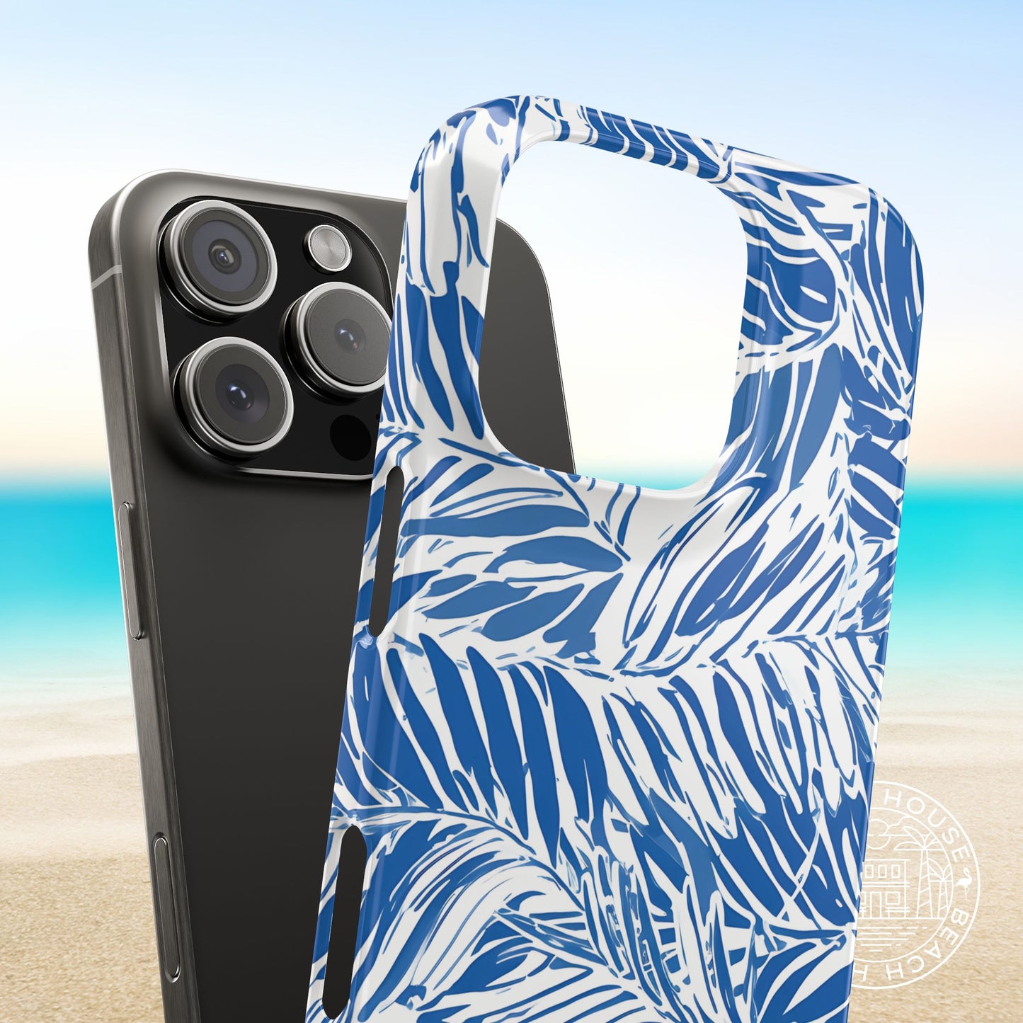 Hampton Slim Case for iPhone with blue and white palm pattern on a beach background
