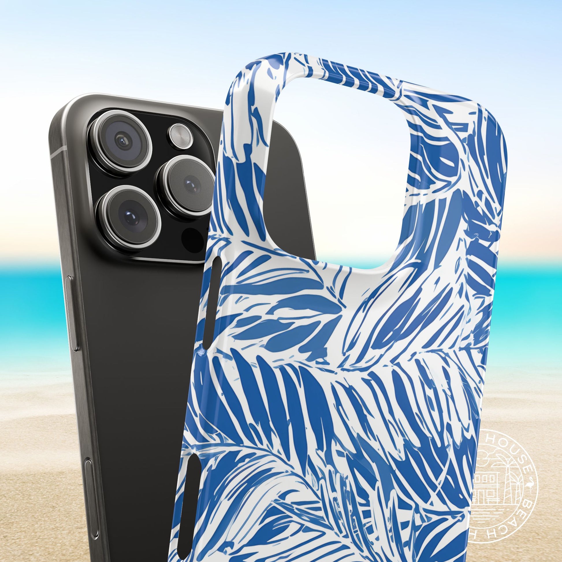 Hampton Slim Case for iPhone with blue and white palm pattern on a beach background