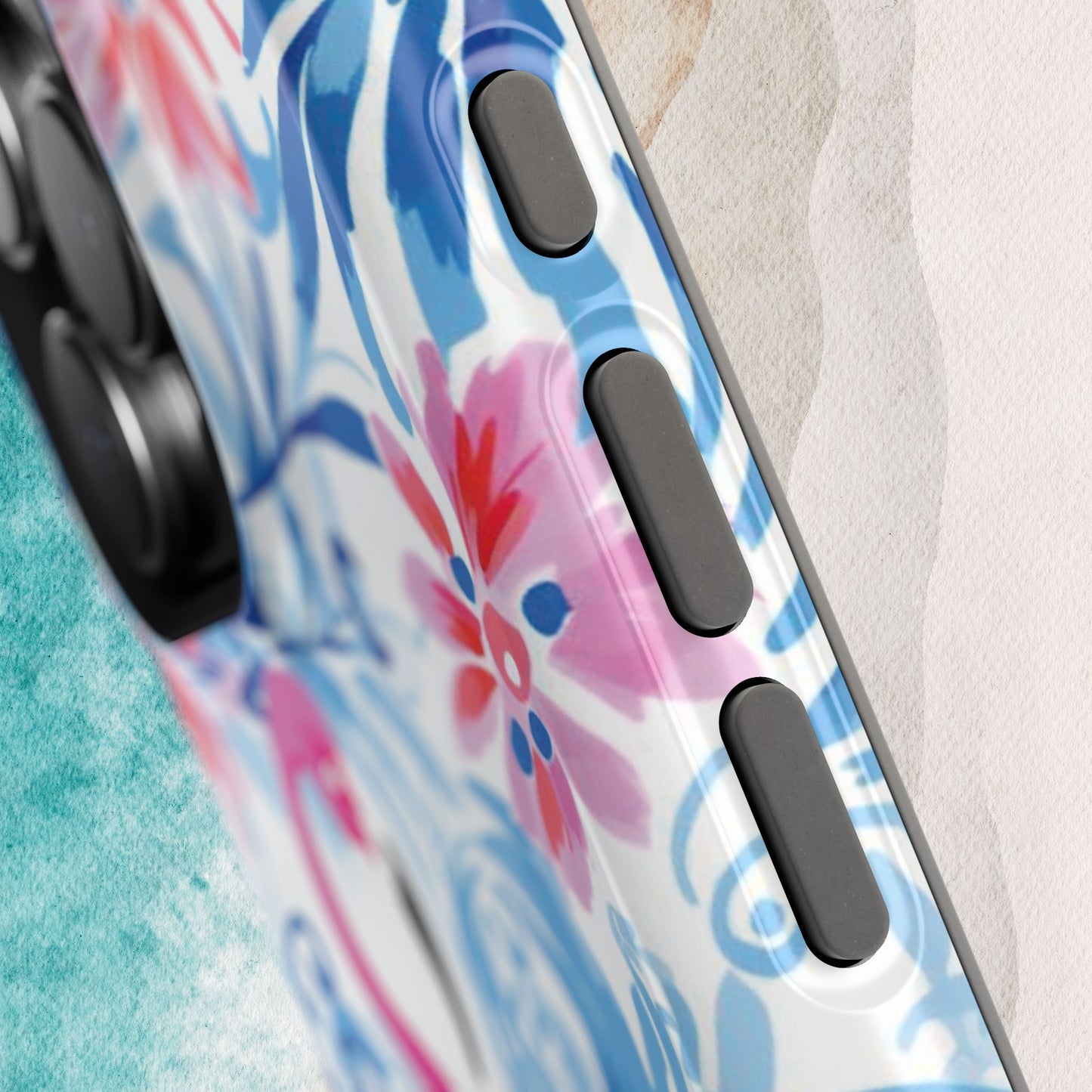 Close up view of side buttons on the Flamingo Beach MagSafe Tough Case for iPhone, on a textured surface