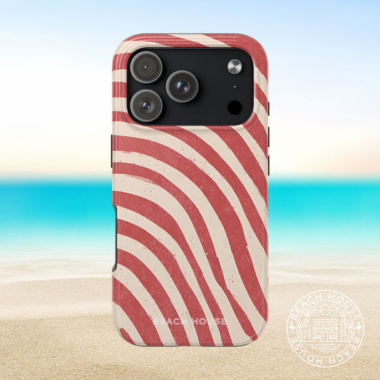 Kure Beach Tough Case for iPhone 17 Pro with red and white striped pattern on a beach background