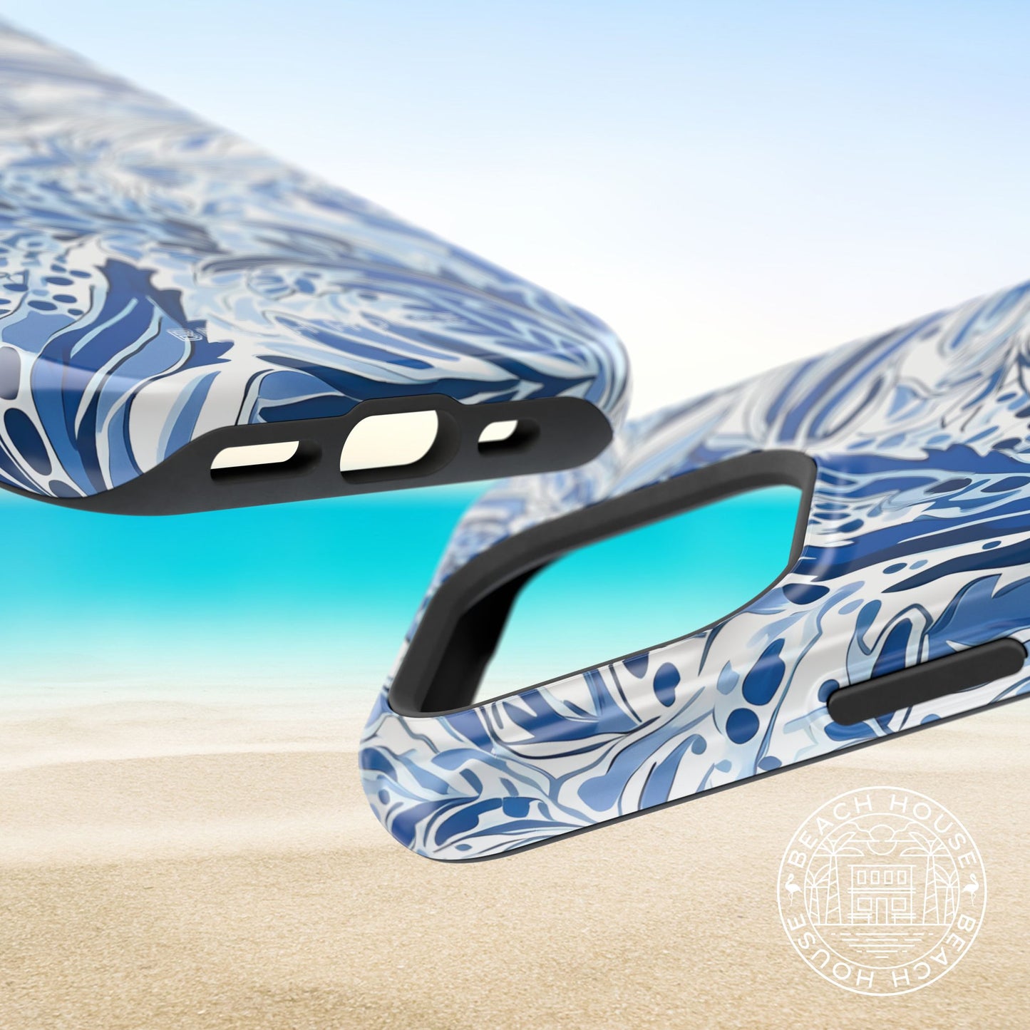 Top and bottom view of the Nags Head MagSafe Tough Case for iPhone on a beach with a clear sky.