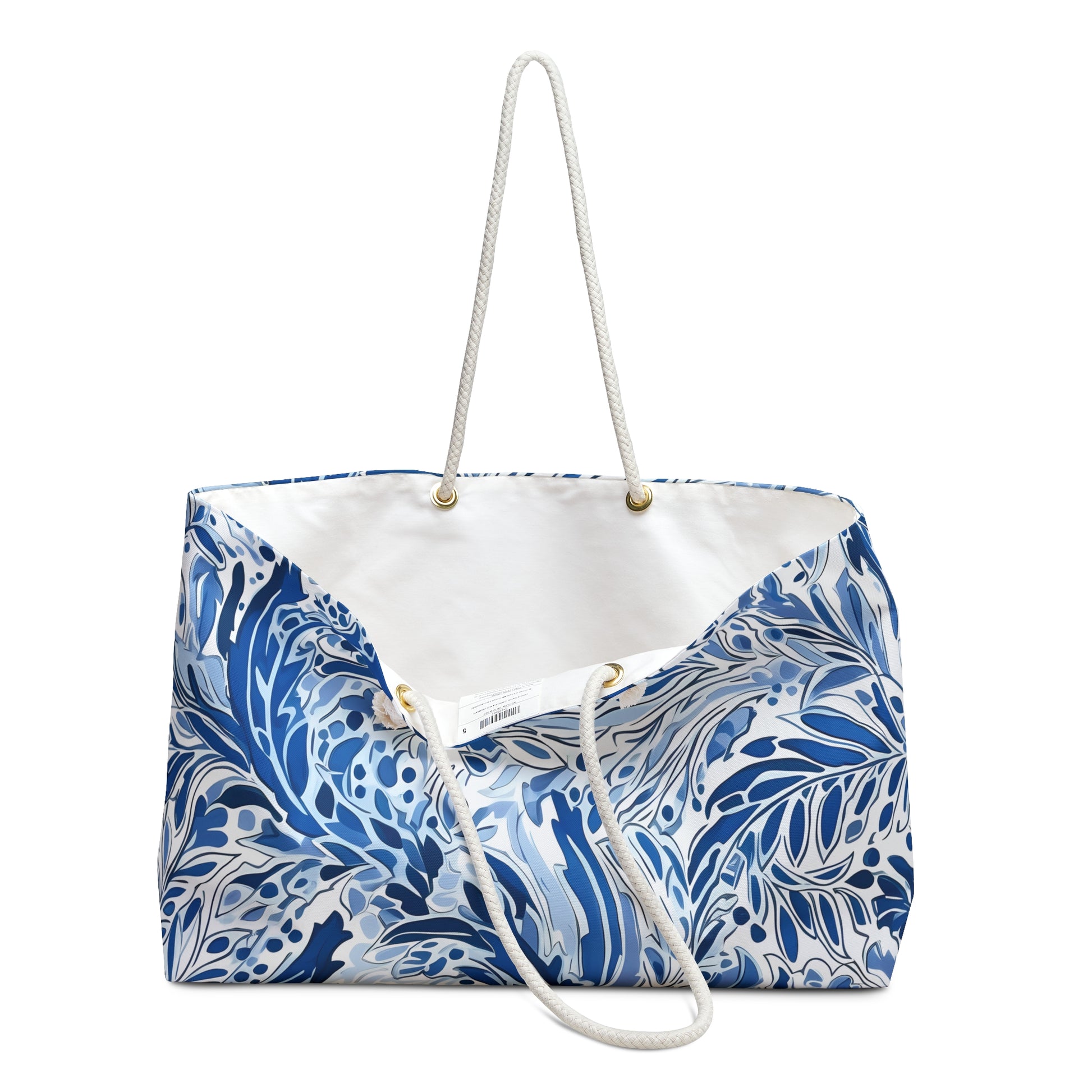 Blue and white Nags Head Weekender bag with a white strap on a white background, sitting slightly opened.