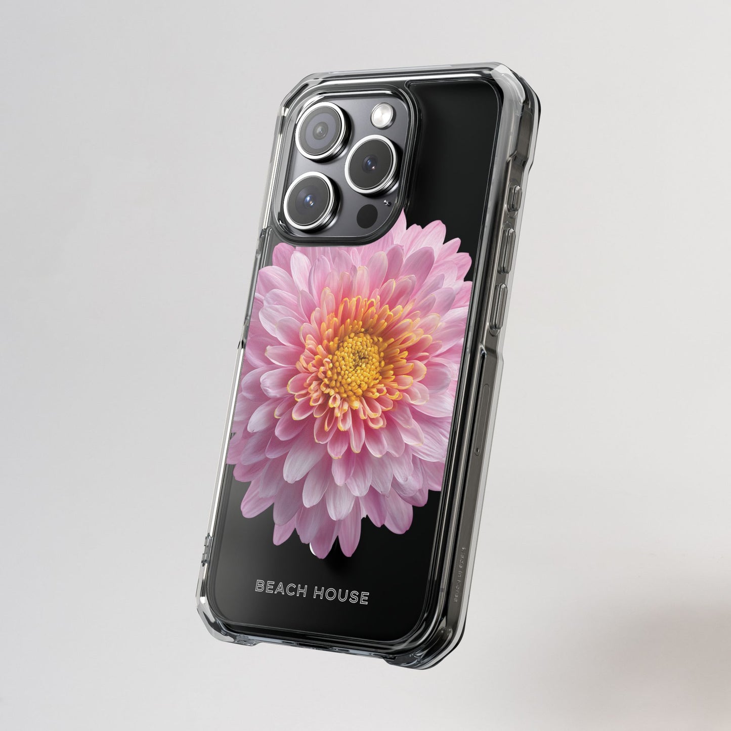 Phone case with a pink flower design on a gray background