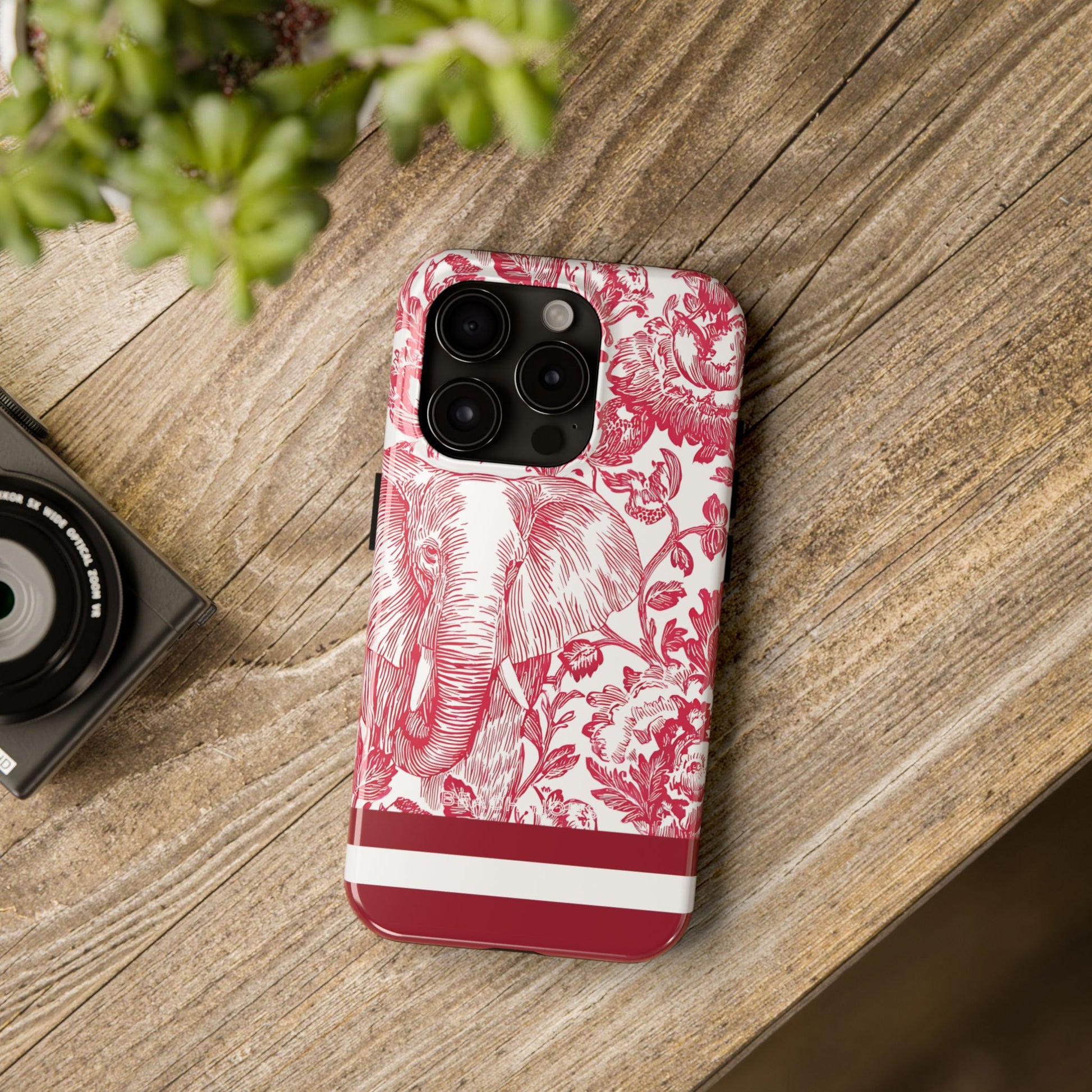 South Bend Tough Case for iPhone with floral and elephant design on a wooden surface