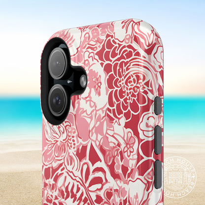 Norman MagSafe Tough Case for iPhone with red and white tropical pattern on a blurred beach background