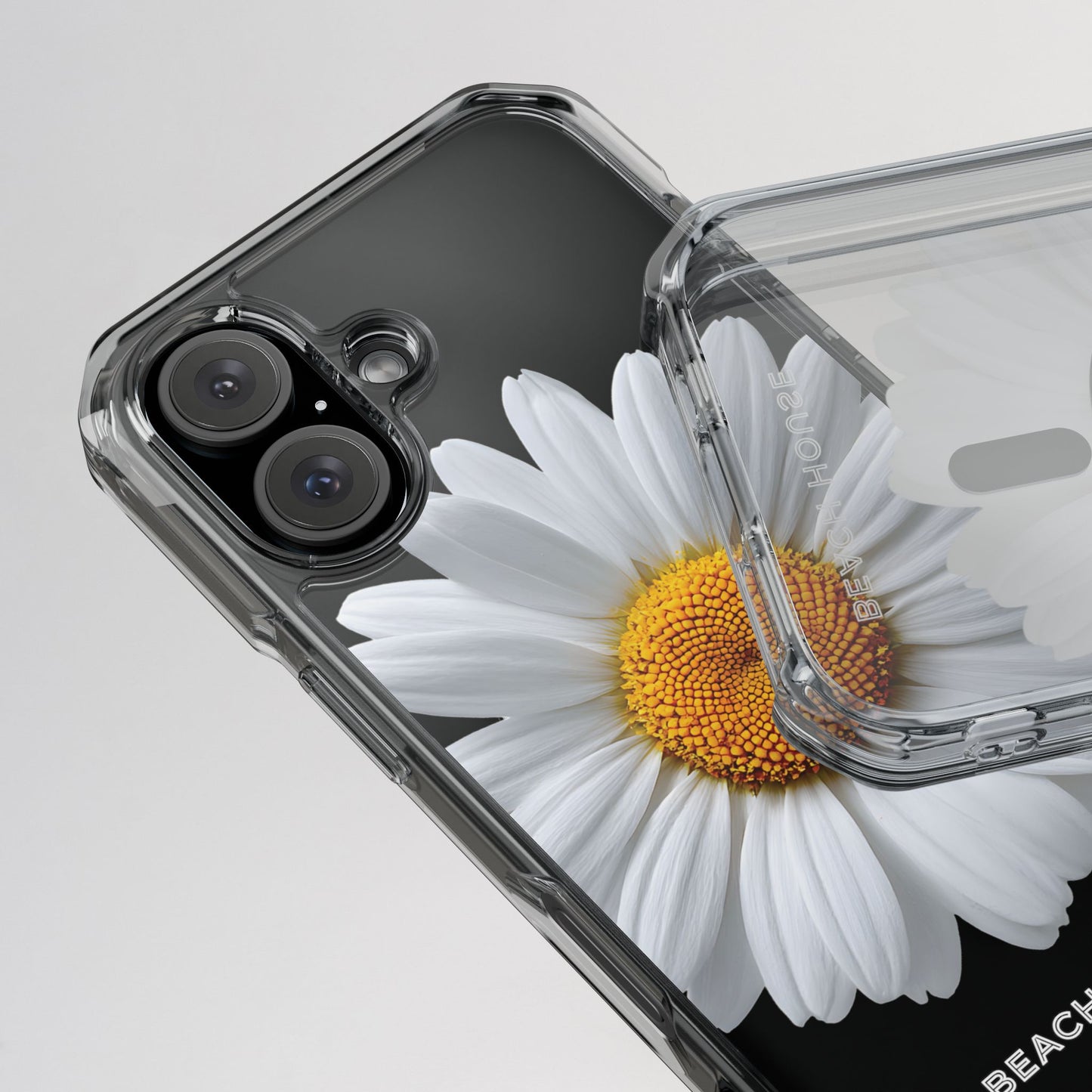 Phone case with a white daisy design on a light gray background