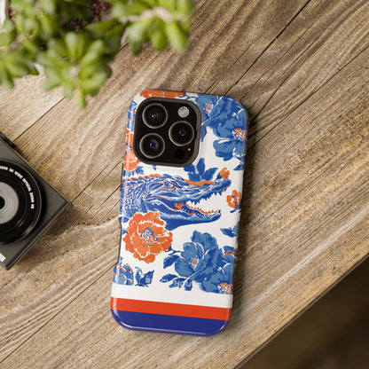Phone case with floral and crocodile design on a wooden surface