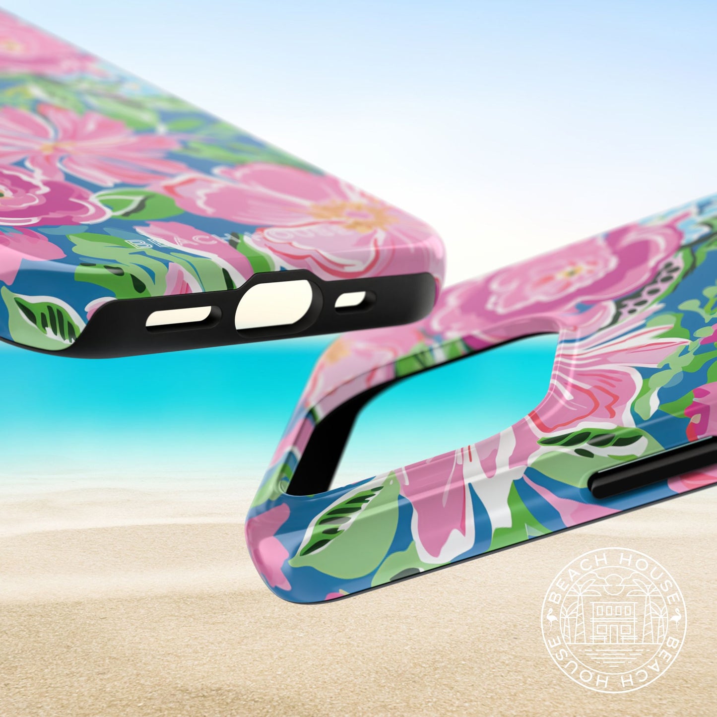 Top and bottom of the Madeira Tough Case for iPhone on a beach with a clear blue sky