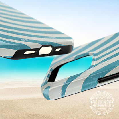 Top and bottom view of the Holmes Beach Tough Case for iPhone on a beach with sand and water in the background.