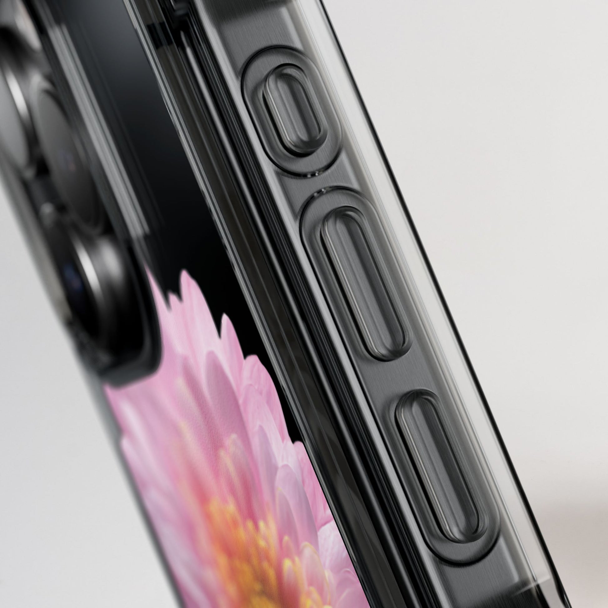 Close-up of a smartphone with a floral display and black case on a light gray background