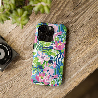 Colorful floral Everglades Tough Case for iPhone on a wooden surface with a camera and plant in the background