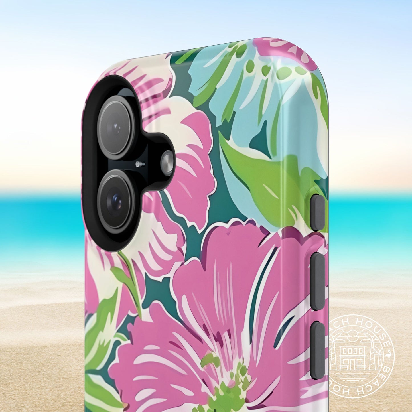 Close up view of the Seaside MagSafe Tough Case for iPhone with pink and green flowers on a beach background