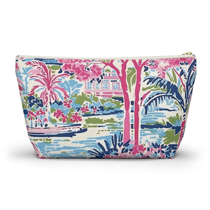 Colorful patterned pouch with palm trees and buildings on a white background