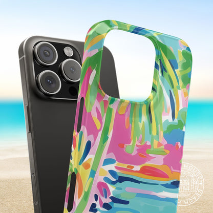 Smartphone with a colorful Delray Slim Case for iPhone on a beach background