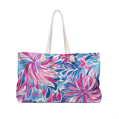 Floral patterned Destin weekender tote bag with a white handle on a white background