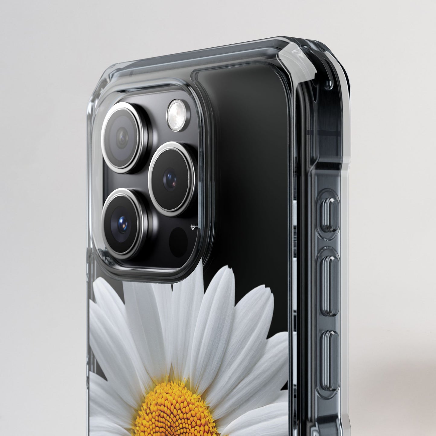 Phone case with a clear design featuring a daisy flower on a light gray background