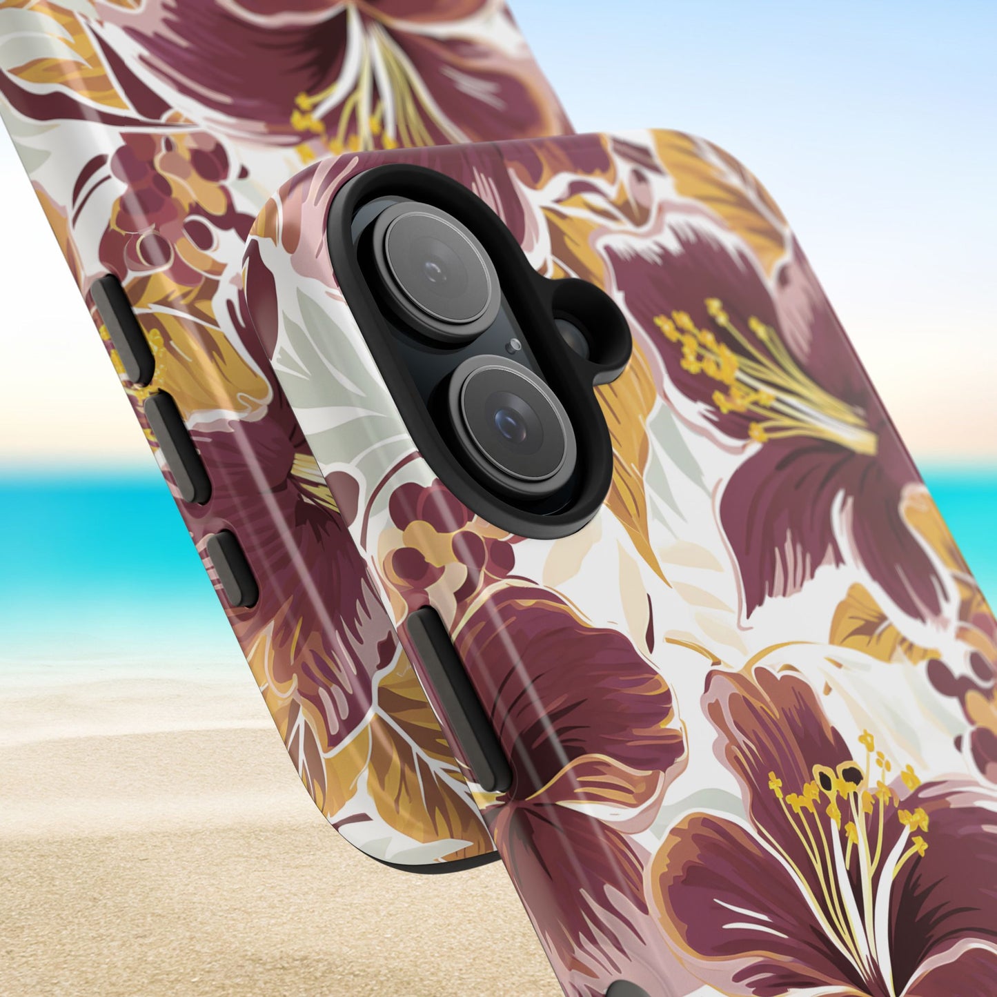 Close up views of the Tallahassee Tough Case for iPhone with garnet and gold tropical design on a beach background