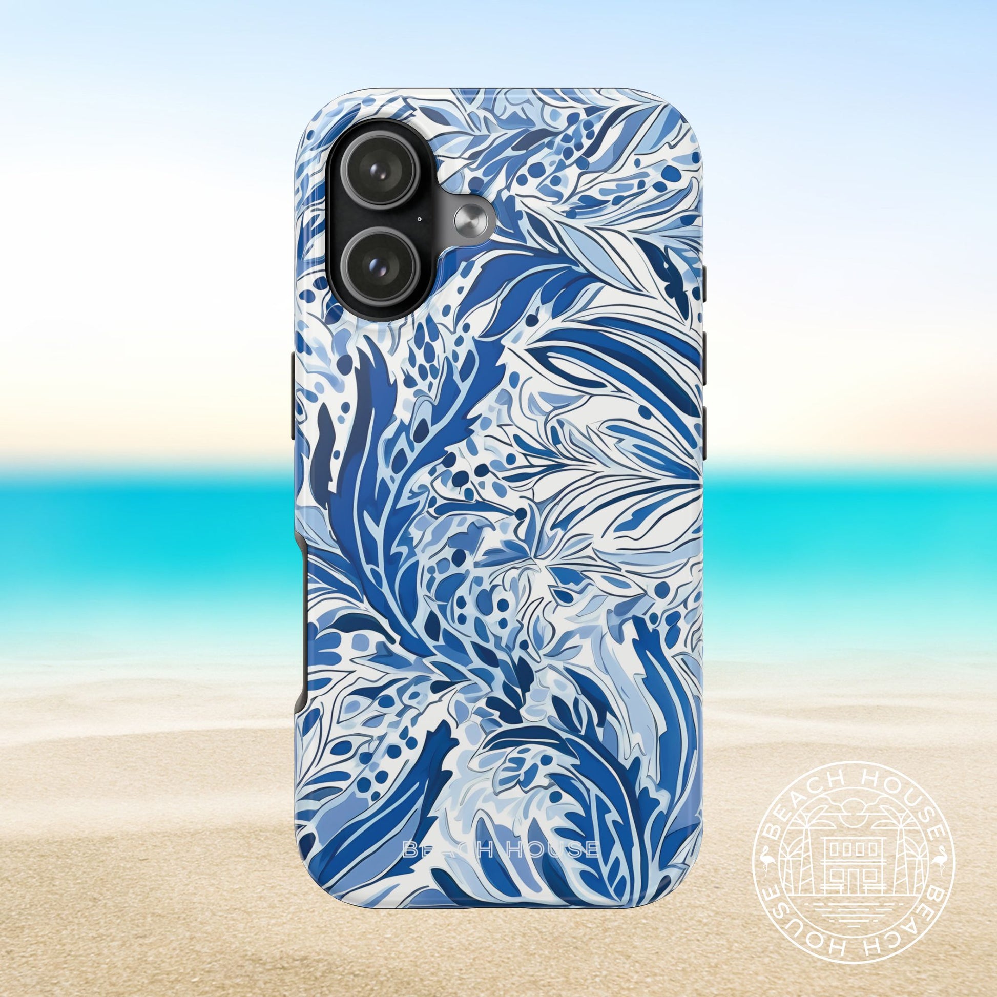 Nags Head case for iPhone 17 with blue floral pattern on a beach background