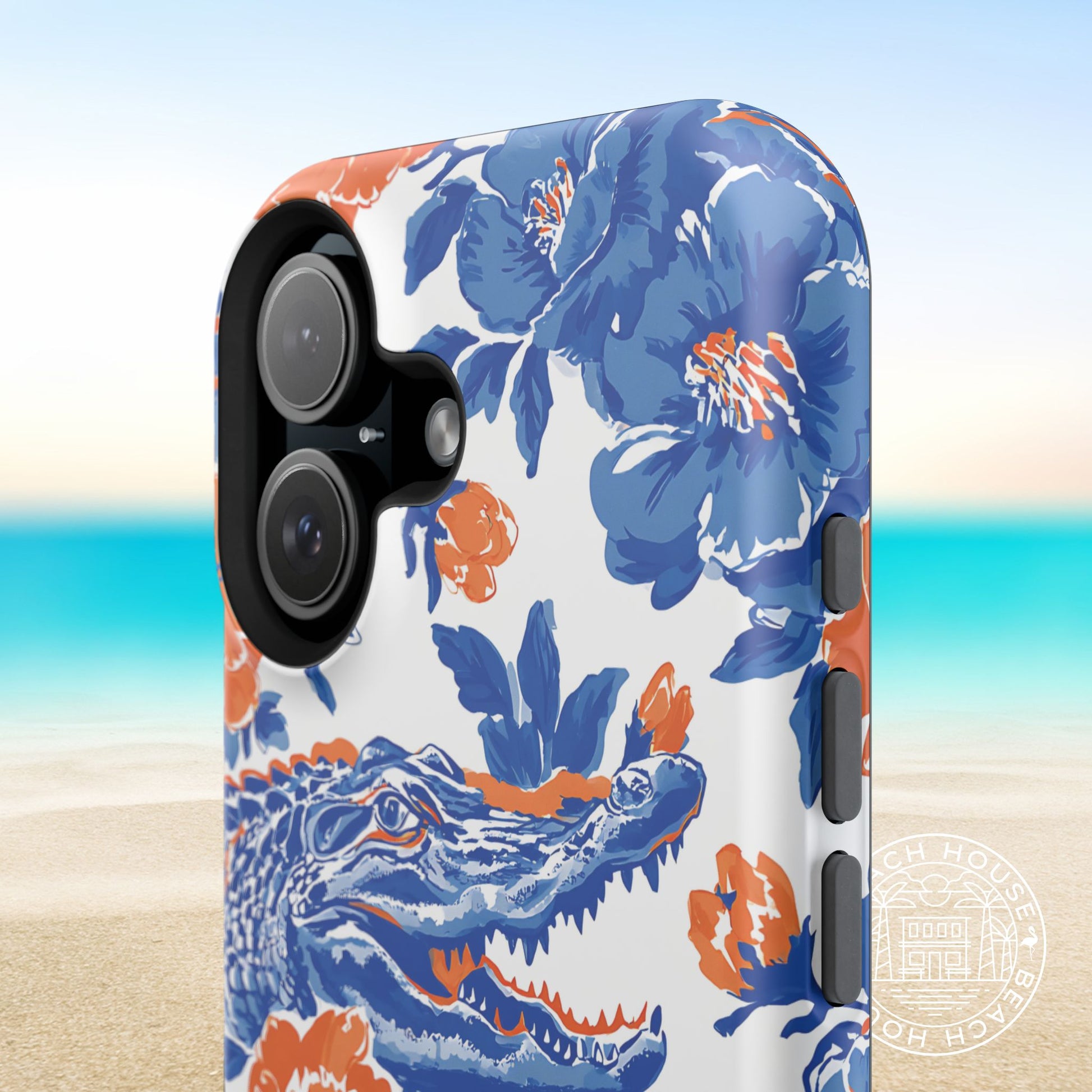 Gainesville MagSafe Tough Case for iPhone with blue floral and alligator design on a beach background