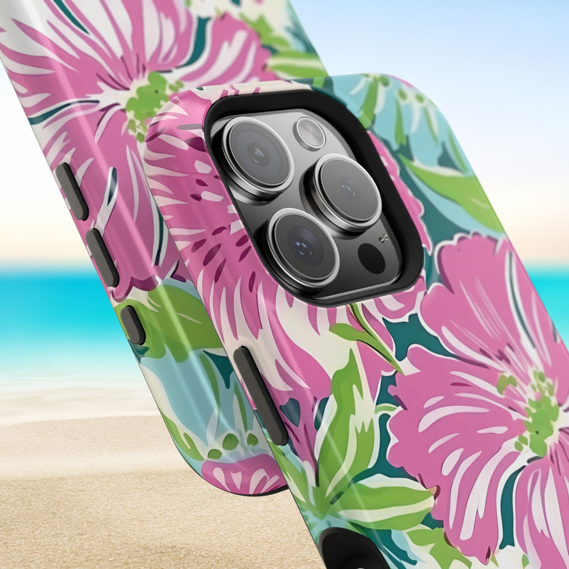 Close up views of the Seaside MagSafe Tough Case for iPhone with pink floral design on a beach background