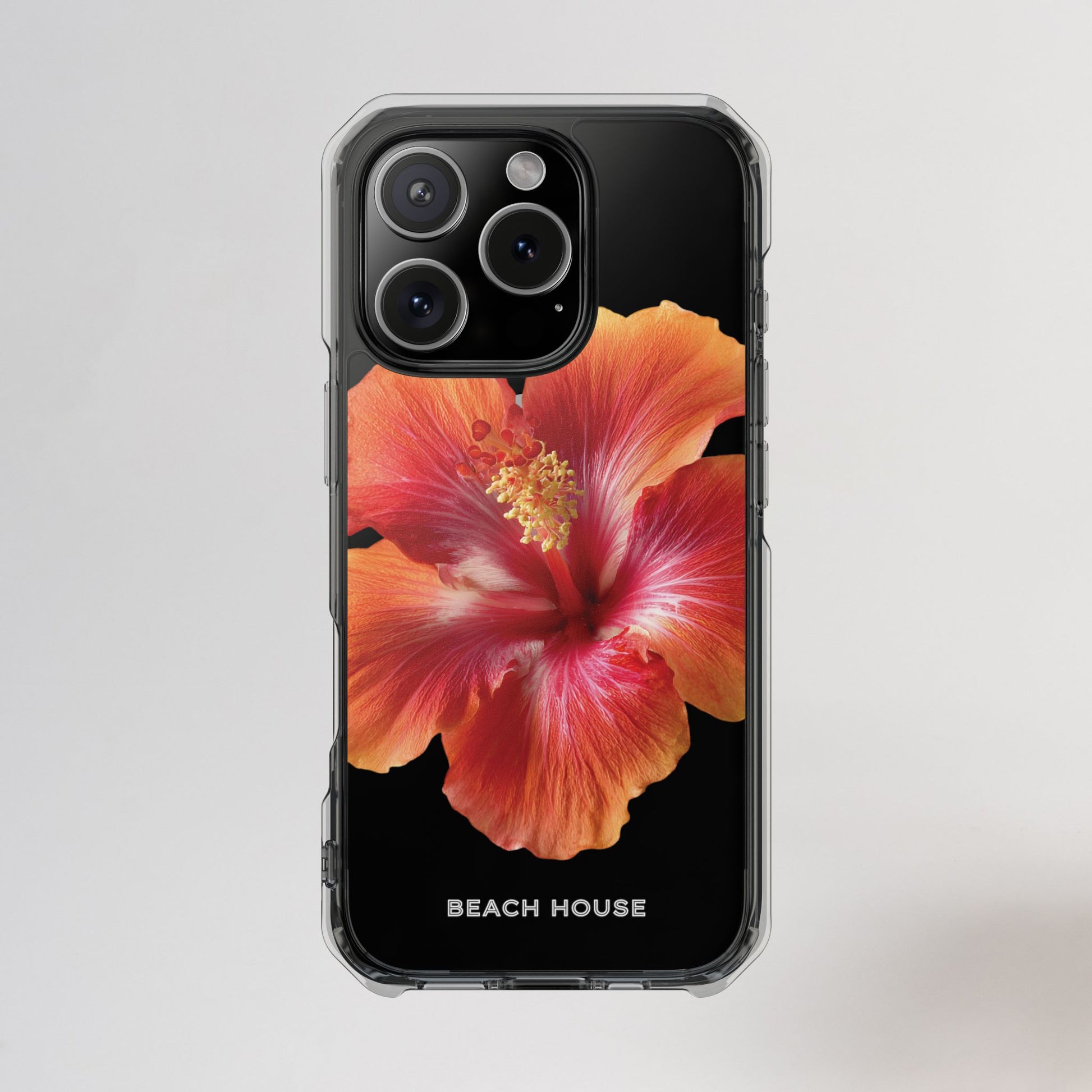 Phone case with a red flower design and 'Beach House' branding on a light gray background