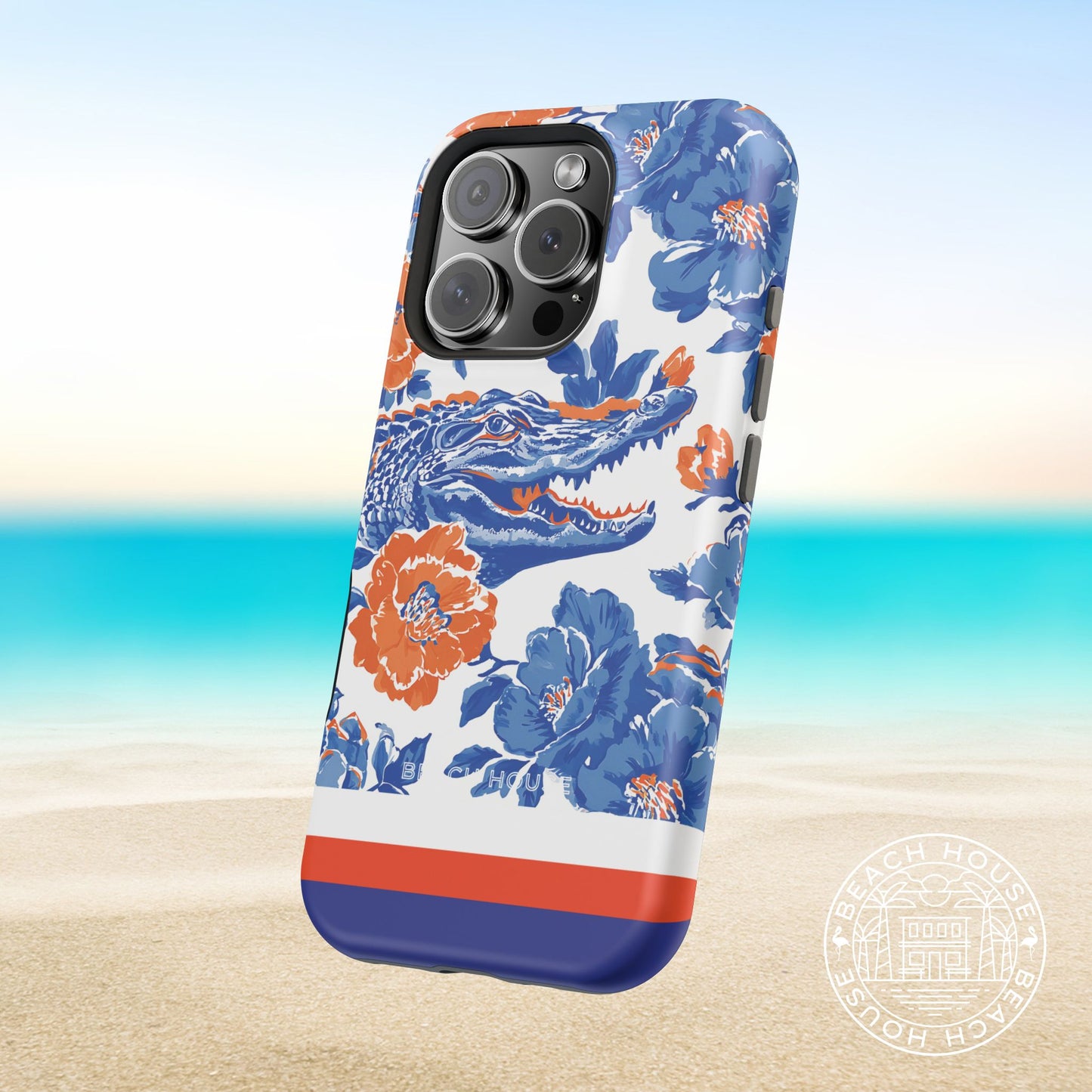Gainesville MagSafe Tough Case for iPhone with orange and blue alligator design on a beach background