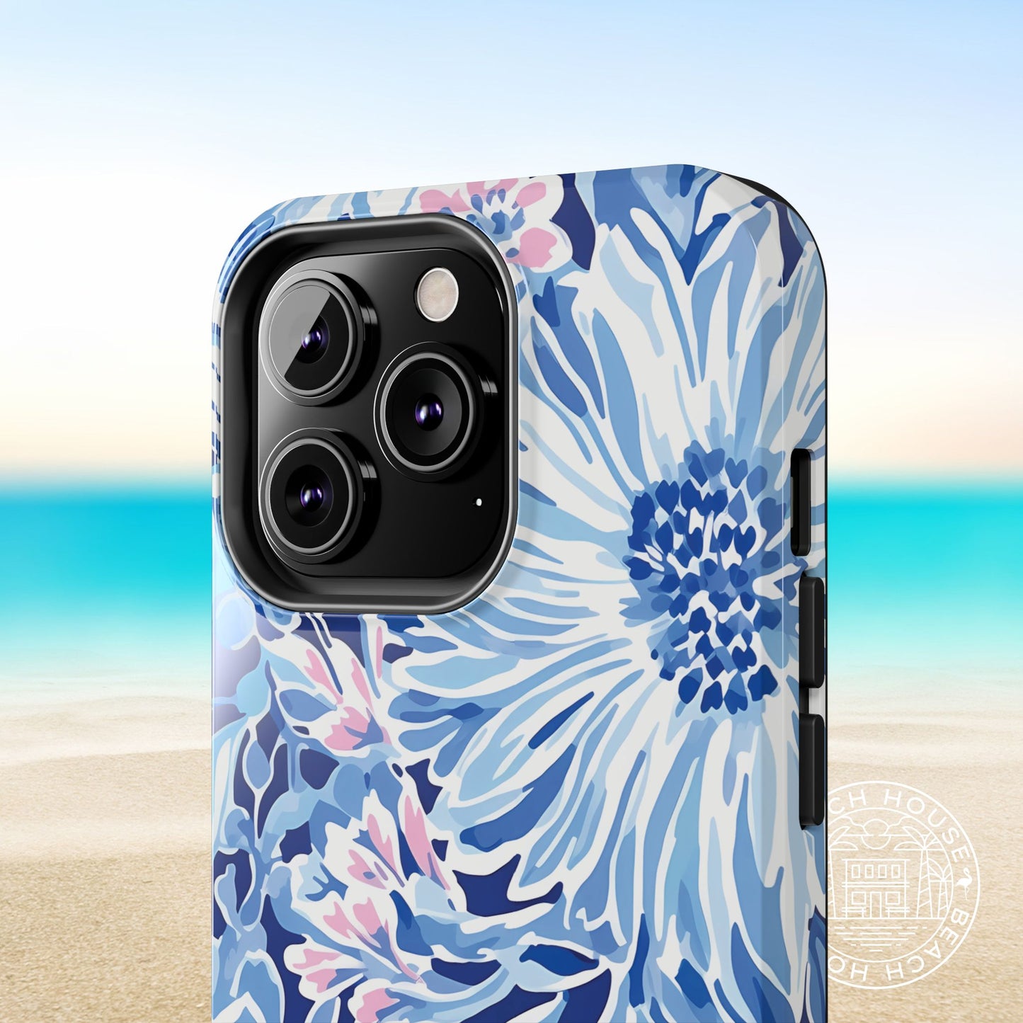Close up view of the coastal floral design of the Huntington Tough Case for iPhone, on a beach background
