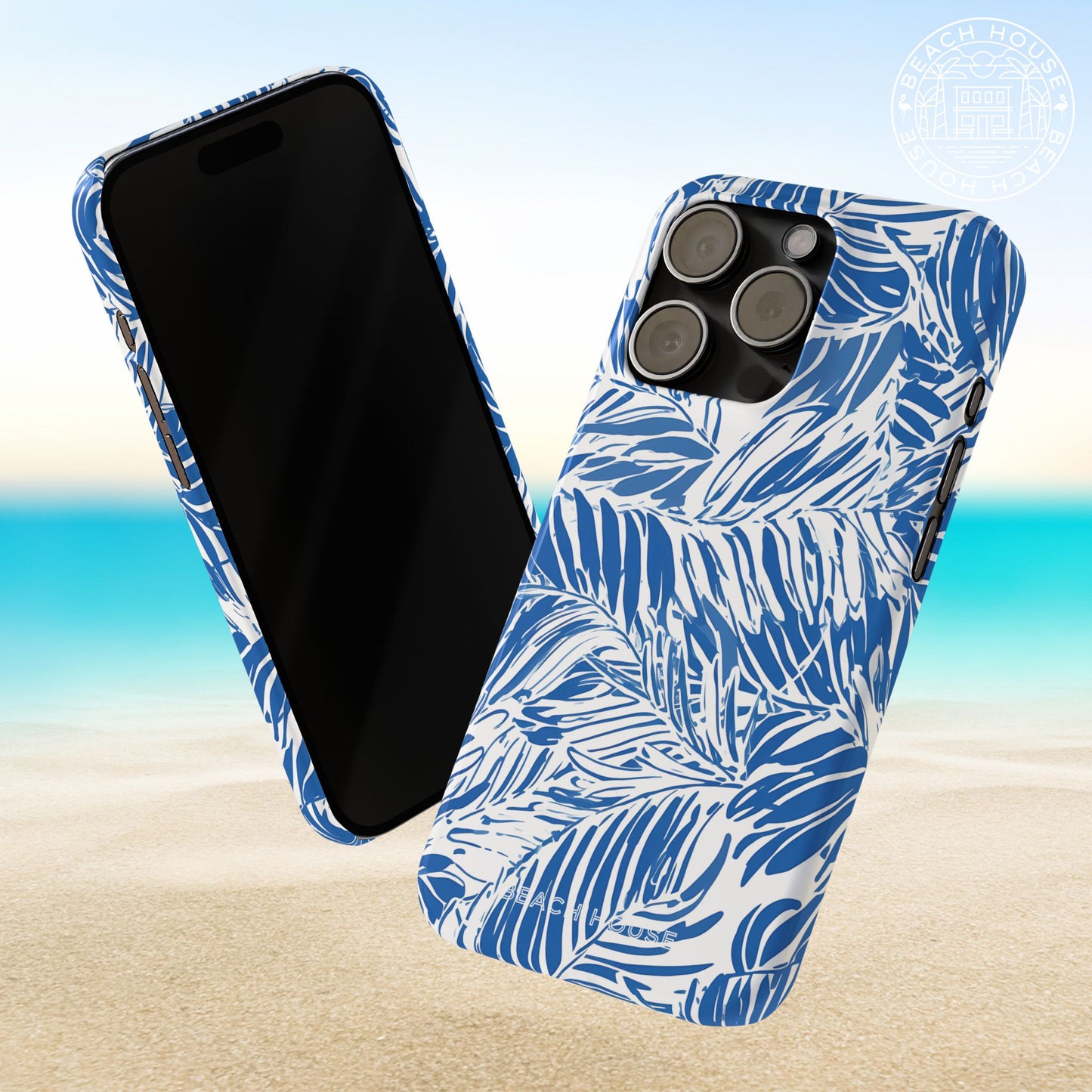 Front and back views of a blue and white Hampton Slim Case for iPhone on a beach background