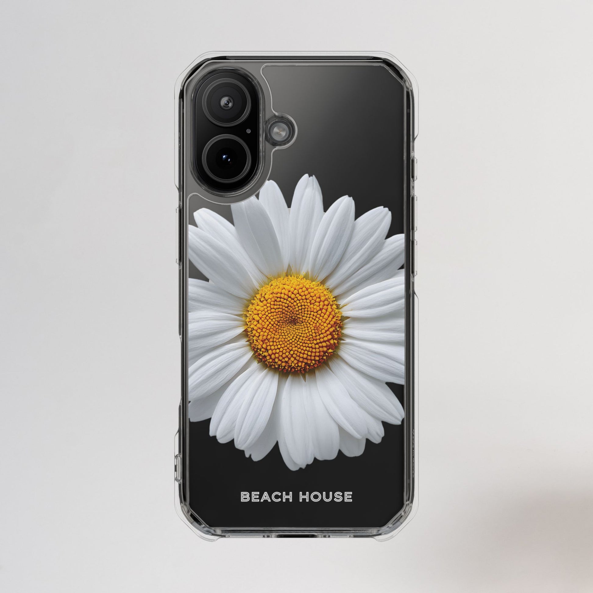 Phone case with a white flower design on a black background