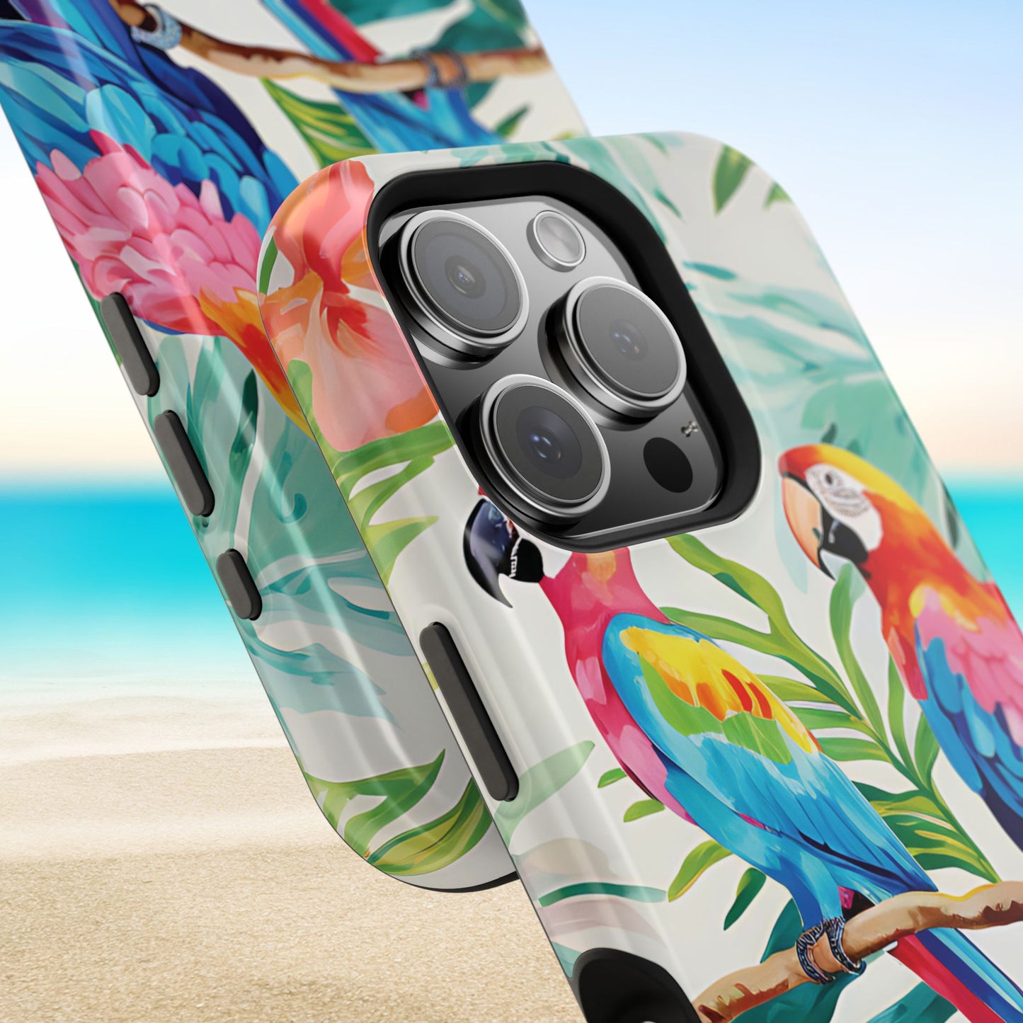 Closeup view of top and bottom of Copacabana MagSafe Tough Case for iPhone with parrot and tropical leaf design on a beach background