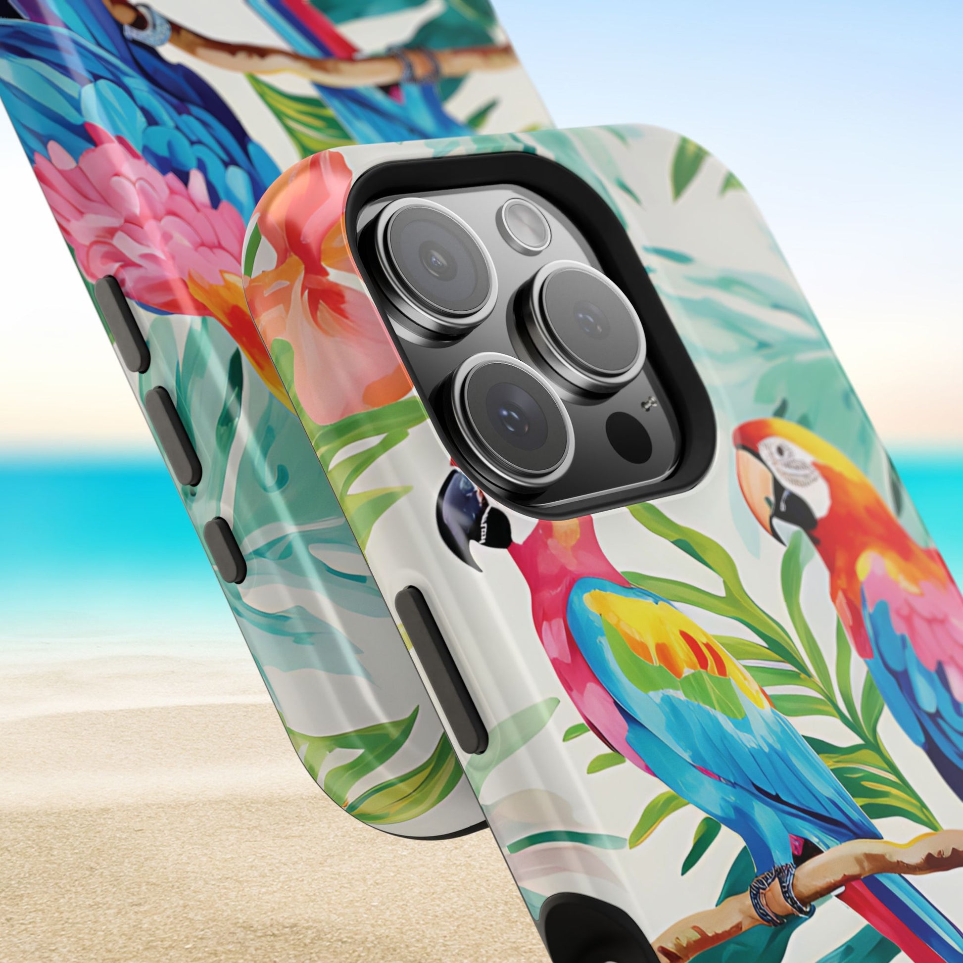 Closeup view of top and bottom of Copacabana MagSafe Tough Case for iPhone with parrot and tropical leaf design on a beach background