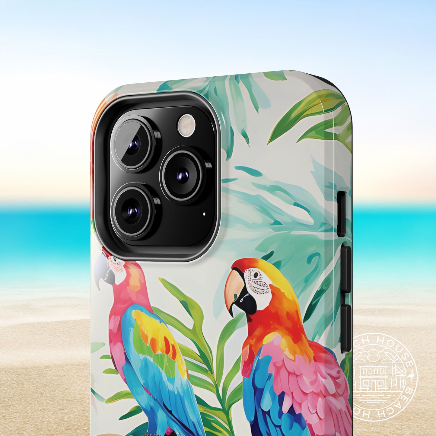 Close up view of the Copacabana Tough Case for iPhone with parrot design on a beach background
