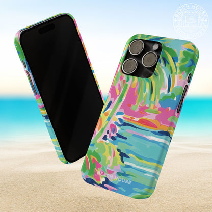 Front and back views of Delray Slim Case for iPhone with tropical design on a beach background