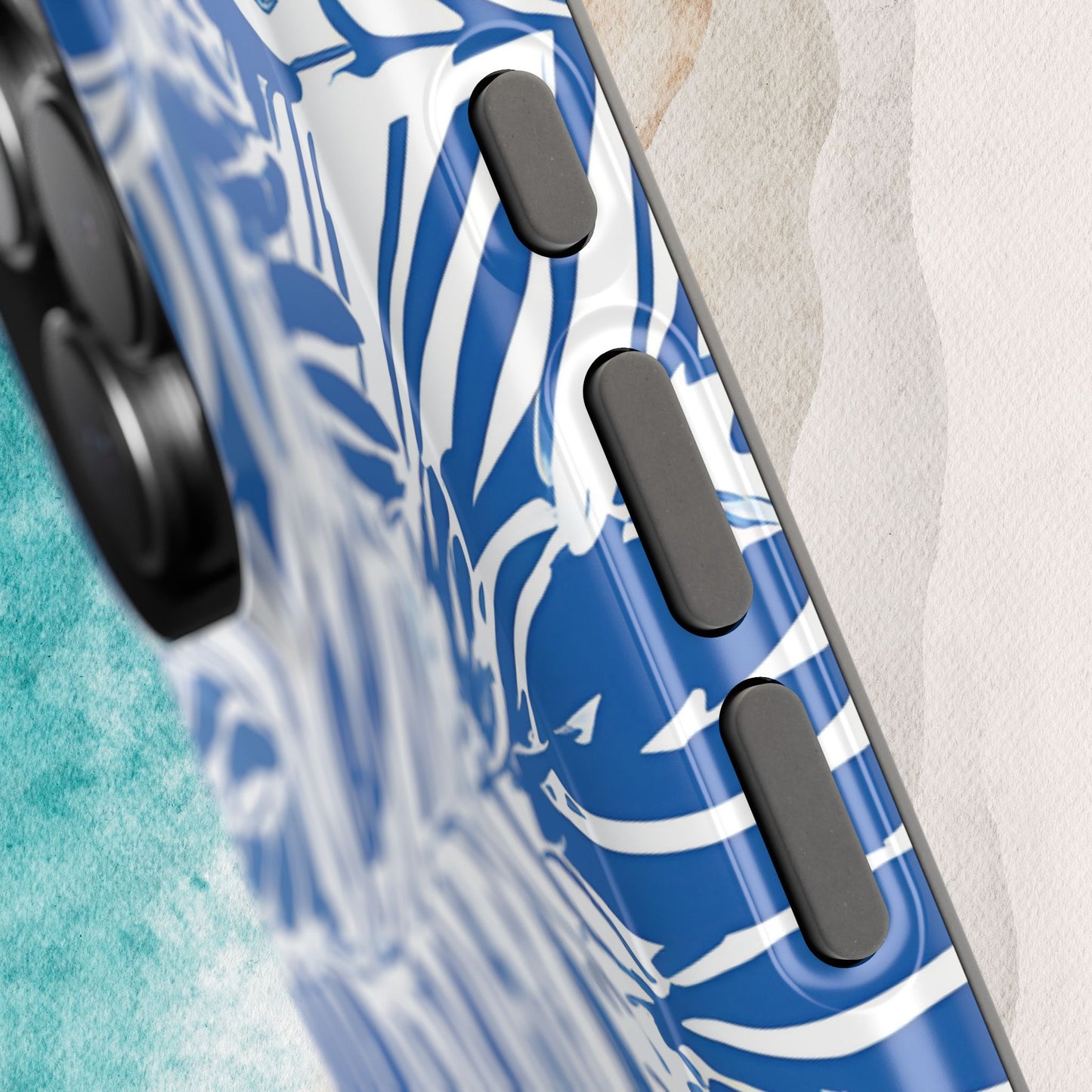 Close up photo of buttons on the Hampton MagSafe Tough Case for iPhone on a textured surface