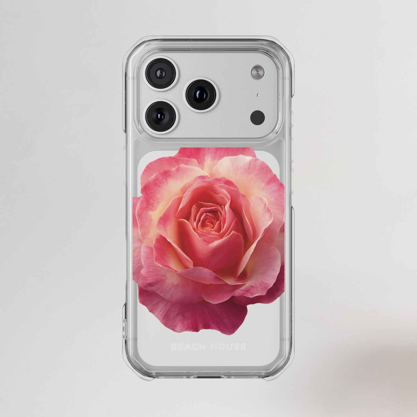 Phone case with a pink rose design on a light gray background